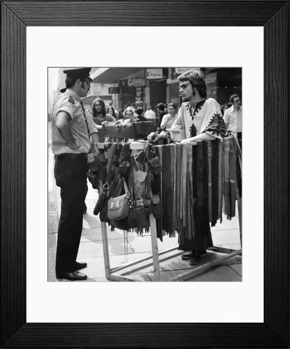 Framed Print : Police have a word with a street trader selling leather goods on Oxford Street Framed Print : Police have a word with a street trader selling leather goods on Oxford Street