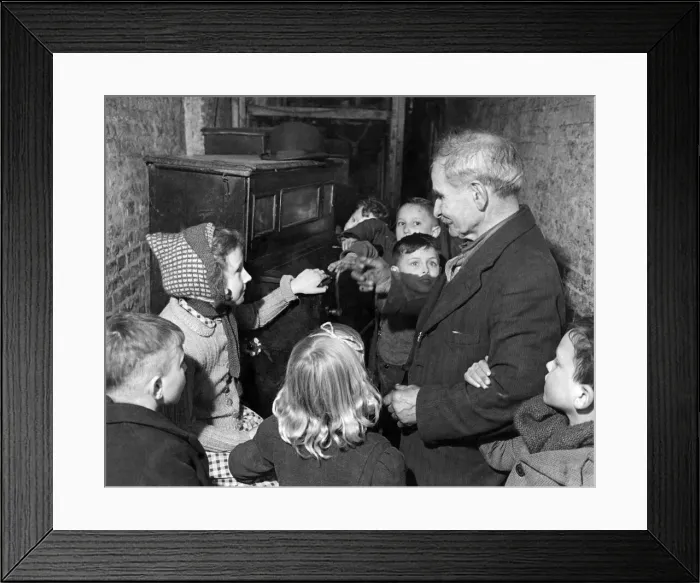 Framed Print : Children listen to a barrel organ being played. February 1944 P004919