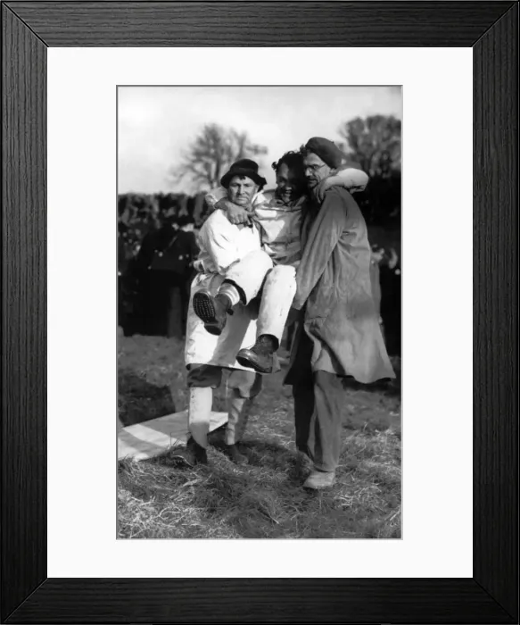 Framed Print : The loser, Ben Hopkins carried away after the contest. His right leg bound with blood