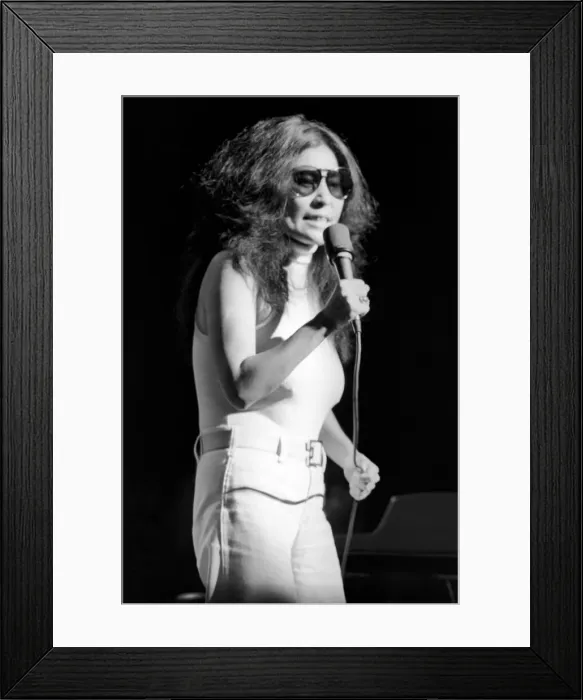 Framed Print : Yoko Ono singing in a charity concert in New York with her husband John Lennon