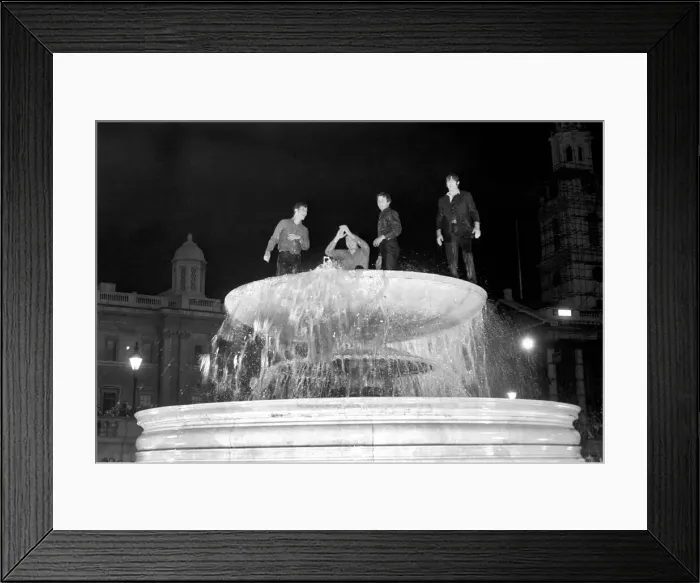 Framed Print : Election night scene in Trafalgar Square. Revellers celebrating in the fountains after Framed Print : Election night scene in Trafalgar Square. Revellers celebrating in the fountains after