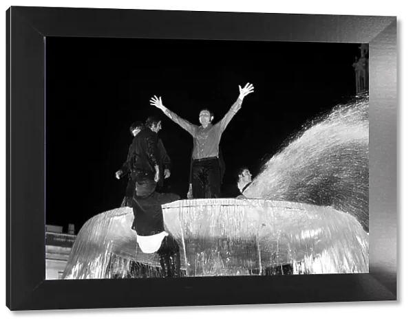 Election night scene in Trafalgar Square. Revellers celebrating in the fountains after