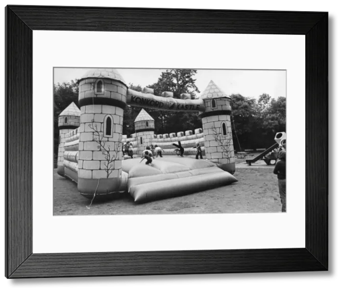 Framed Print : Children enjoy a bouncy castle Framed Print : Children enjoy a bouncy castle