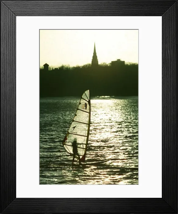 Framed Print : A windsurfer enjoys the sunshine despite the freezing temperatures on Edgbaston Reservoir