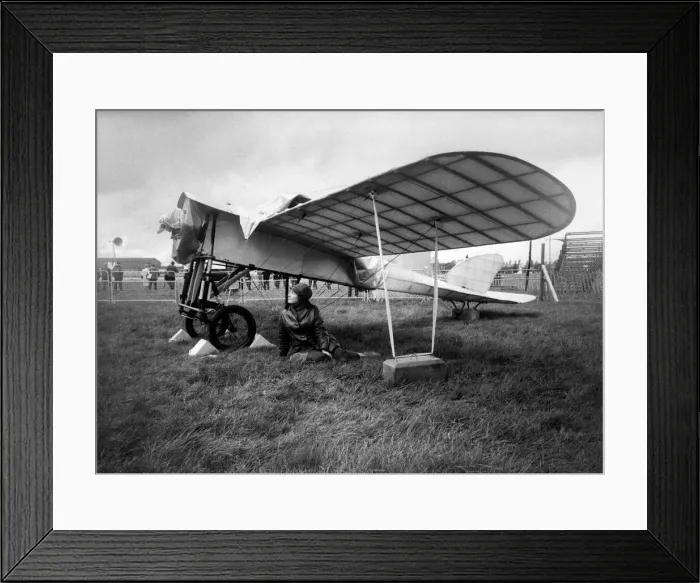 Framed Print : 27 year old Gina McEvoy of Berkshire, sheltering from the rain under the wing of a 1911 Framed Print : 27 year old Gina McEvoy of Berkshire, sheltering from the rain under the wing of a 1911