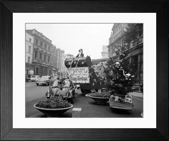 Framed Print : This illuminated sleigh towed'by a Volkswagon Beetle car with a reindeer