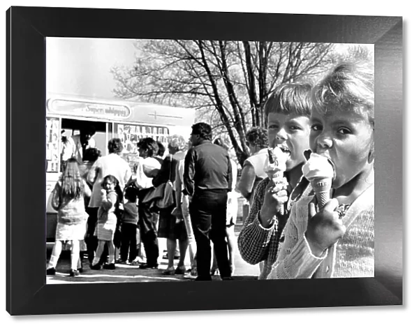A young boy and girl enjoy their ice creams at Wyken Slough pool, Coventry