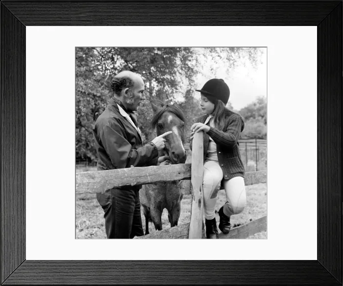 Framed Print : Sterling Moss (Ex Racing Driver). Seen here with horse and daughter. June 1974 S74-3861 Framed Print : Sterling Moss (Ex Racing Driver). Seen here with horse and daughter. June 1974 S74-3861