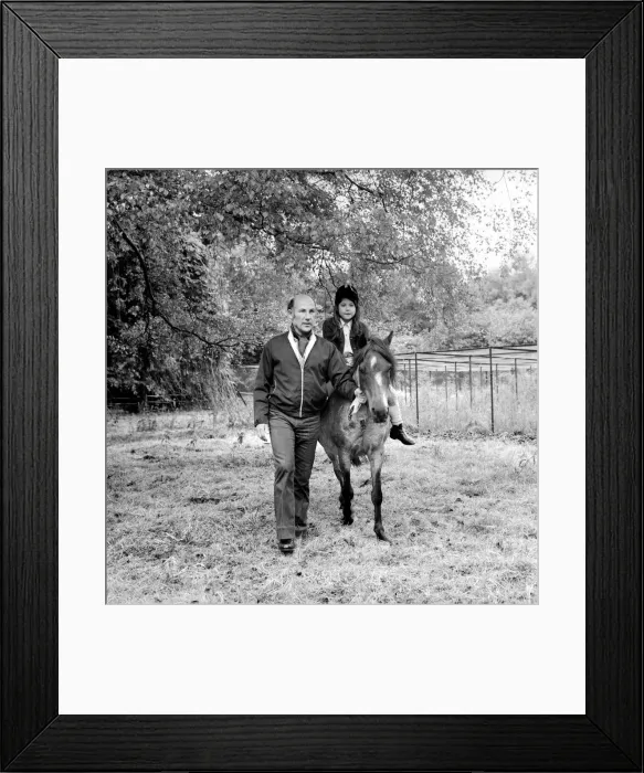 Framed Print : Sterling Moss (Ex Racing Driver). Seen here with horse and daughter Framed Print : Sterling Moss (Ex Racing Driver). Seen here with horse and daughter
