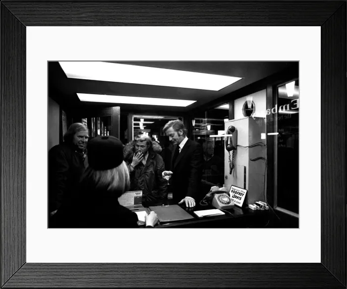 Framed Print : Film legend Michael Caine off-camera with a glass of wine in Godrey Davies car hire