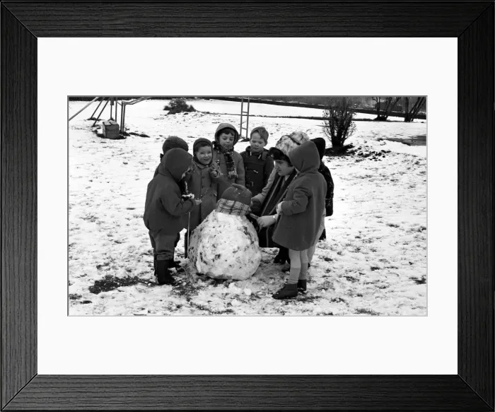 Framed Print : All eyes on teacher as she puts the finishing touches to asnowman at Binley Nursery Schoo Framed Print : All eyes on teacher as she puts the finishing touches to asnowman at Binley Nursery Schoo