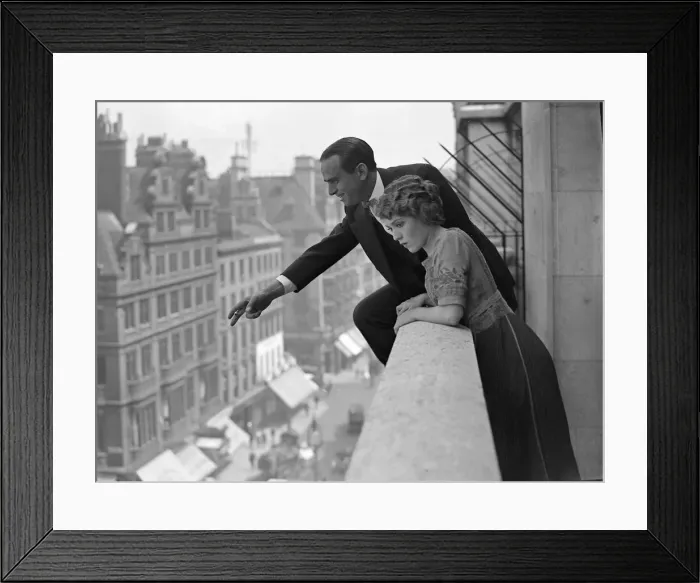 Framed Print : Actor Douglas Fairbanks seen here with his wife throwing roses from the balcony of Framed Print : Actor Douglas Fairbanks seen here with his wife throwing roses from the balcony of