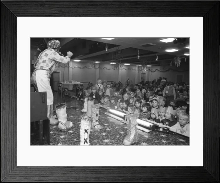 Framed Print : Bill Gore, the singing cobbler, entertains children at a party in the Lockhead ballroom