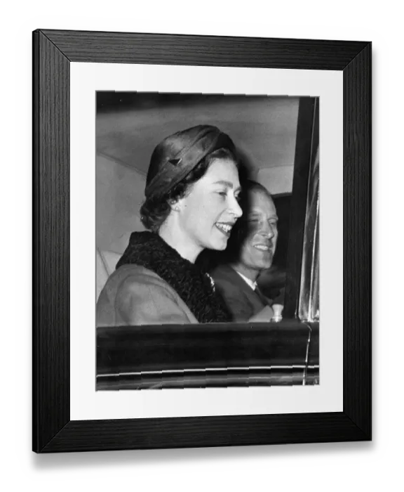 Framed Print : Queen Elizabeth II and Prince Philip smiling as they drive through the streets of