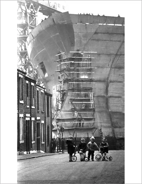 Children playing in the shadow of the giant 253, 000-ton oil tanker Esso Northumbria which