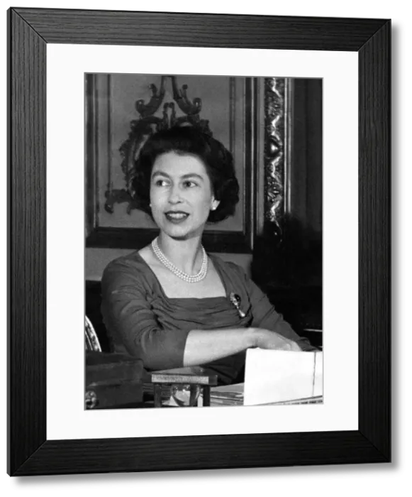 Framed Print : Queen Elizabeth II at her desk in Buckingham Palace looking through her correspondence Framed Print : Queen Elizabeth II at her desk in Buckingham Palace looking through her correspondence