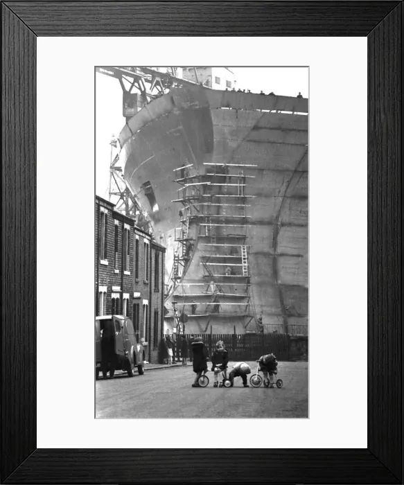 Framed Print : Children playing in the shadow of the giant 253, 000-ton oil tanker Esso Northumbria which Framed Print : Children playing in the shadow of the giant 253, 000-ton oil tanker Esso Northumbria which