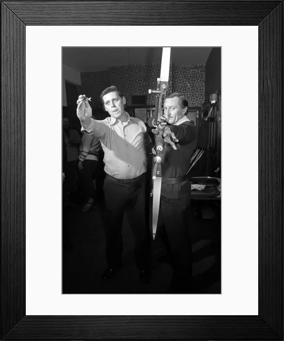 Framed Print : Archers challenge darts players to a game of darts, with the Archers using their bows Framed Print : Archers challenge darts players to a game of darts, with the Archers using their bows