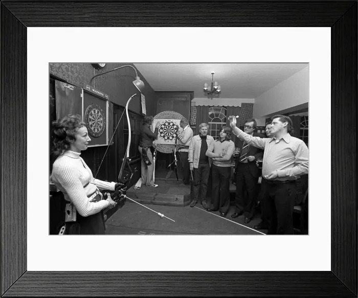 Framed Print : Archers challenge darts players to a game of darts, with the Archers using their bows Framed Print : Archers challenge darts players to a game of darts, with the Archers using their bows