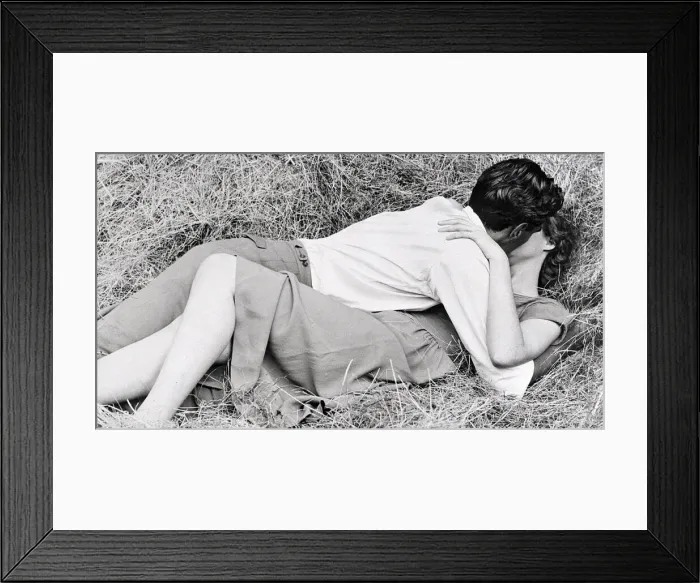 Framed Print : This couple in love found the perfect spot in the hay for their kiss