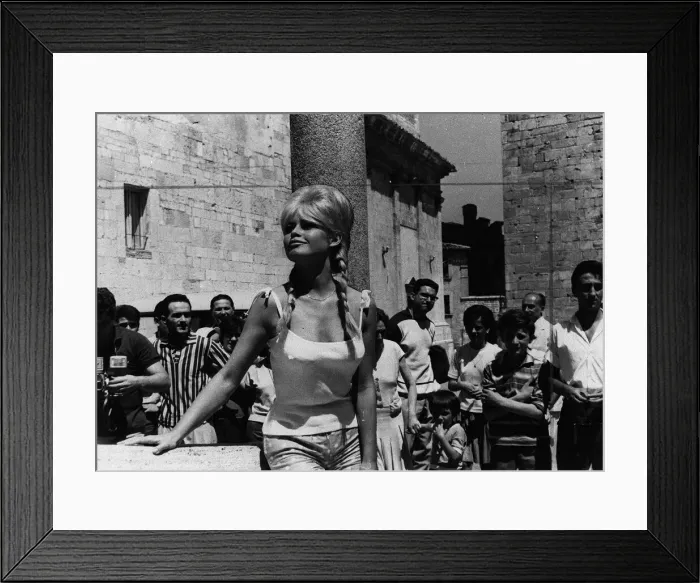 Framed Print : Brigitte Bardot 1961 posing for photographers in Italy for a final scene in Framed Print : Brigitte Bardot 1961 posing for photographers in Italy for a final scene in