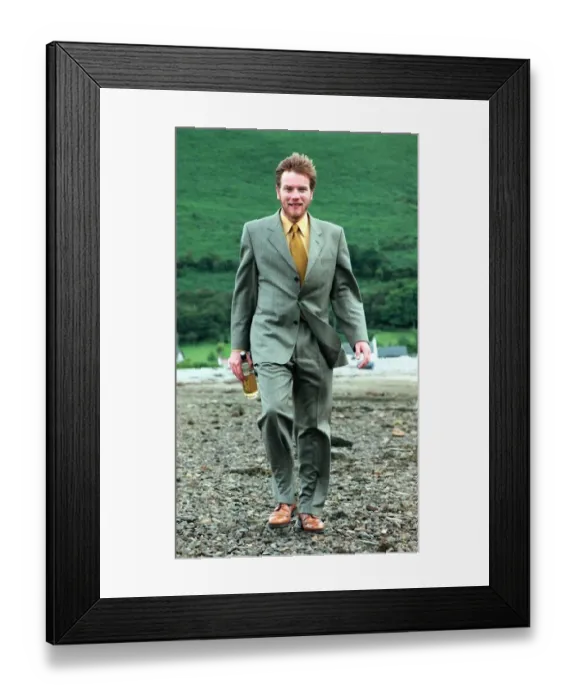Framed Print : Ewan McGregor on the Isle of Arran July 1998 with bottle of Loch Ranza whisky