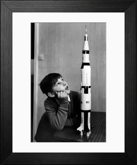 Framed Print : Toys-Space Rockets: Paul Ward of Belgravia, studies a model of the Apollo 12 rocket