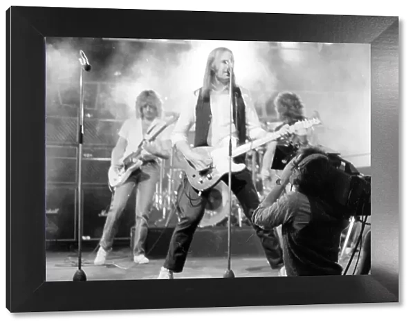 Status Quo performing on stage on BBC TV Programme 'Top of the Pops'March 1982