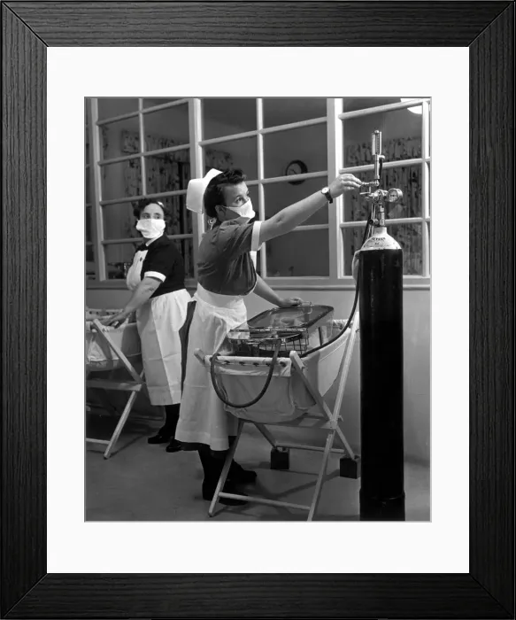 Framed Print : A nurse in the maternity unit of a hospital keeps an eye on the pressure from the oxygen Framed Print : A nurse in the maternity unit of a hospital keeps an eye on the pressure from the oxygen