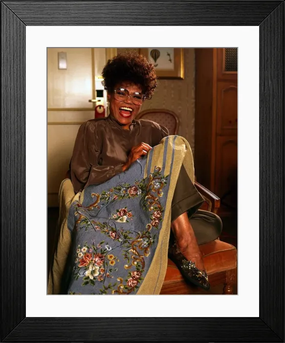 Framed Print : American singer and actress Eartha Kitt sewing a dress. September 1989 Framed Print : American singer and actress Eartha Kitt sewing a dress. September 1989