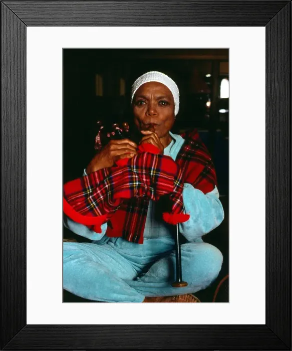 Framed Print : American singer and actress Eartha Kitt blowing into bagpipes November 1989