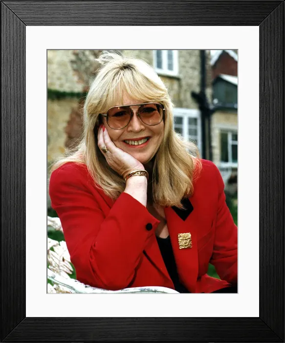 Framed Print : Cynthia Lennon wearing red jacket dark glasses December 1995
