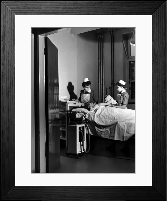 Framed Print : Midwives deliver a new born baby inside thew Labour ward at the British Hospital for Framed Print : Midwives deliver a new born baby inside thew Labour ward at the British Hospital for