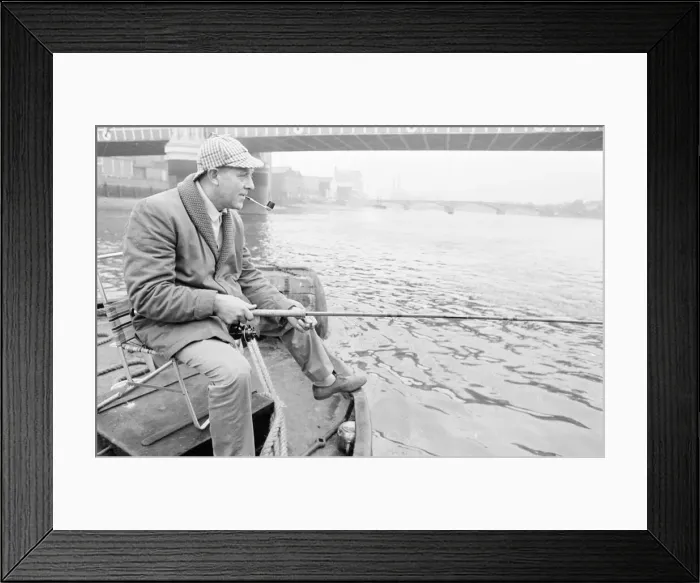 Framed Print : An angler from the Soho Firestation seen here fishing off a barge moored close to Framed Print : An angler from the Soho Firestation seen here fishing off a barge moored close to