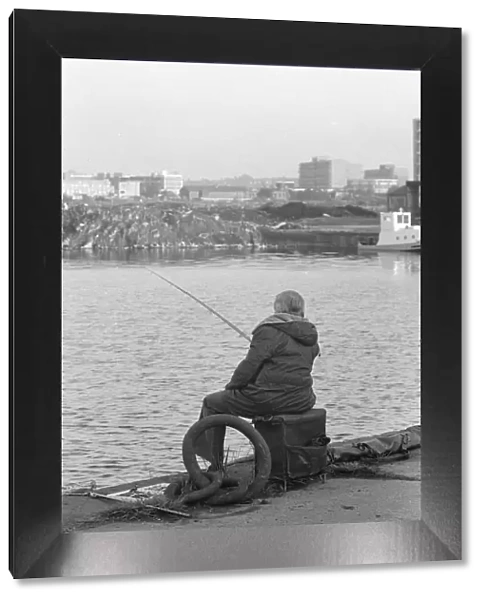 A competitor in the Daily MIrror Angling Competition at Surrey Docks, London