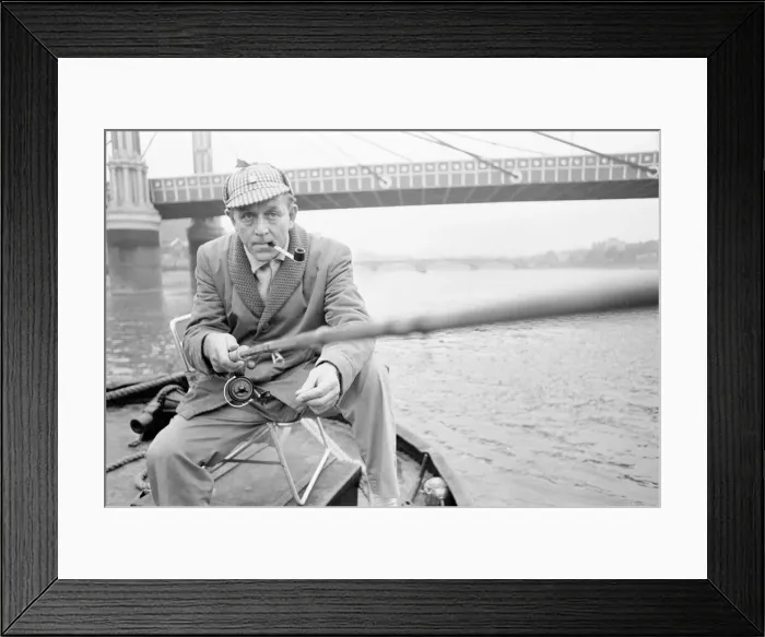Framed Print : An angler from the Soho Firestation seen here fishing off a barge moored close to Framed Print : An angler from the Soho Firestation seen here fishing off a barge moored close to