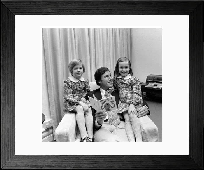 Framed Print : Childrens book writer Roger Hargreaves reading one of his stories to his twins Framed Print : Childrens book writer Roger Hargreaves reading one of his stories to his twins