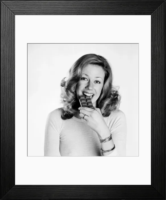 Framed Print : Woman eating chocolate. February 1975 75-00891-002