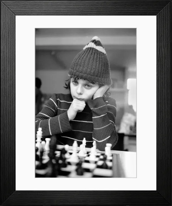 Framed Print : East End Kids Chess Congress: A West Ham supporter, complete with his West Ham hat makes