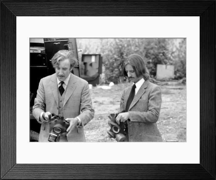 Framed Print : Peter Sellers and Ringo Starr prepare to put on gas masks in a scene from the film