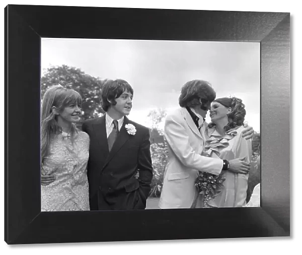 Mike McCartneys Wedding. Mike McGear kisses bride Angela watched by his