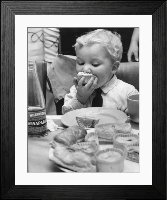 Framed Print : Christmas party at Shipcote Fire Station - Alan Kain downs a cream cake while keep an eye