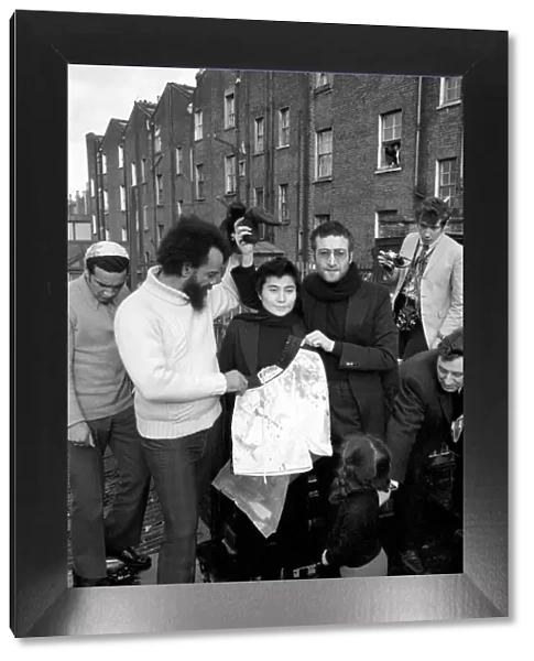 John Lennon and Yoko pictured on the roof of Black House in Holloway Road, with Michael X