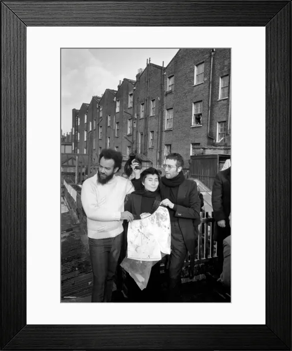 Framed Print : John Lennon and Yoko pictured on the roof of Black House in Holloway Road, with Michael X