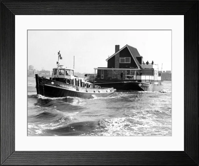 Framed Print : A tug boat hauling a floating home along to its new site on the River Thames September Framed Print : A tug boat hauling a floating home along to its new site on the River Thames September