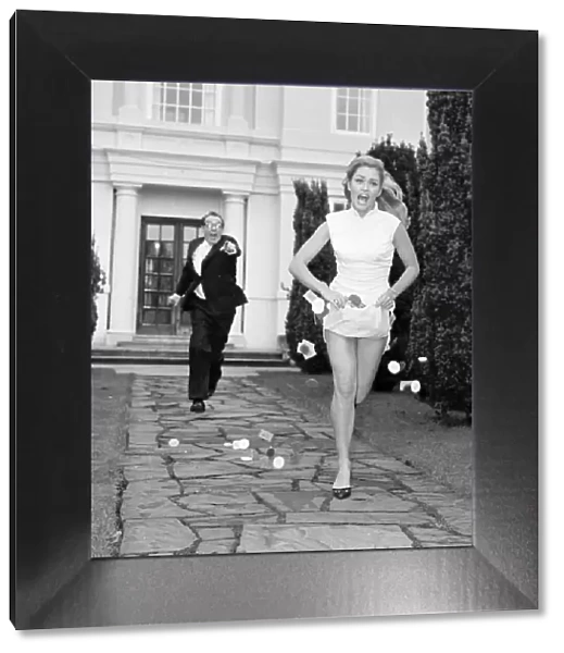 Actress Alexandra Bastedo seen here being chased by Eric Morecombe whilst filming a