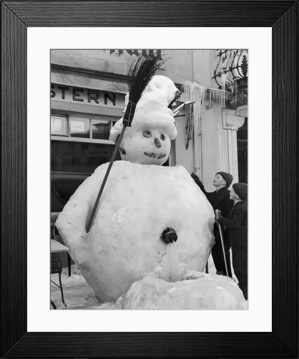 Framed Print : Giant snowman built over a public water tap in the centre of St Moritz, Switzerland