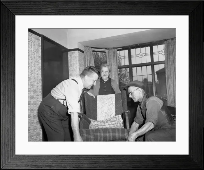 Framed Print : Painters and decorators seen here removing the furniture before they start work as a Framed Print : Painters and decorators seen here removing the furniture before they start work as a