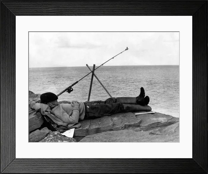 Framed Print : Fishing - A fisherman takes a nap whilst fishing of some rocks - South Wales - 24th July Framed Print : Fishing - A fisherman takes a nap whilst fishing of some rocks - South Wales - 24th July