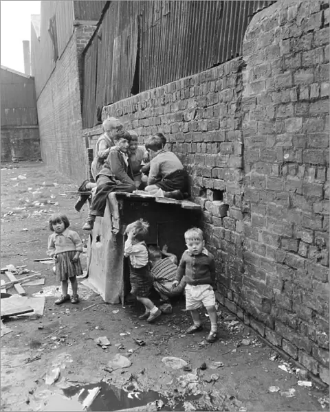 Children playing in the back alleys of a Goven tenement block. September 1956
